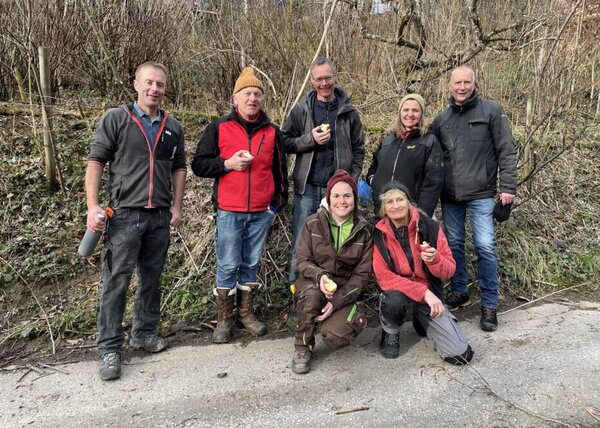 Die sieben Teilnehmenden des Kurs Obstbäume richtig schneiden stehen für ein Gruppenfoto auf einem Kiesweg. 